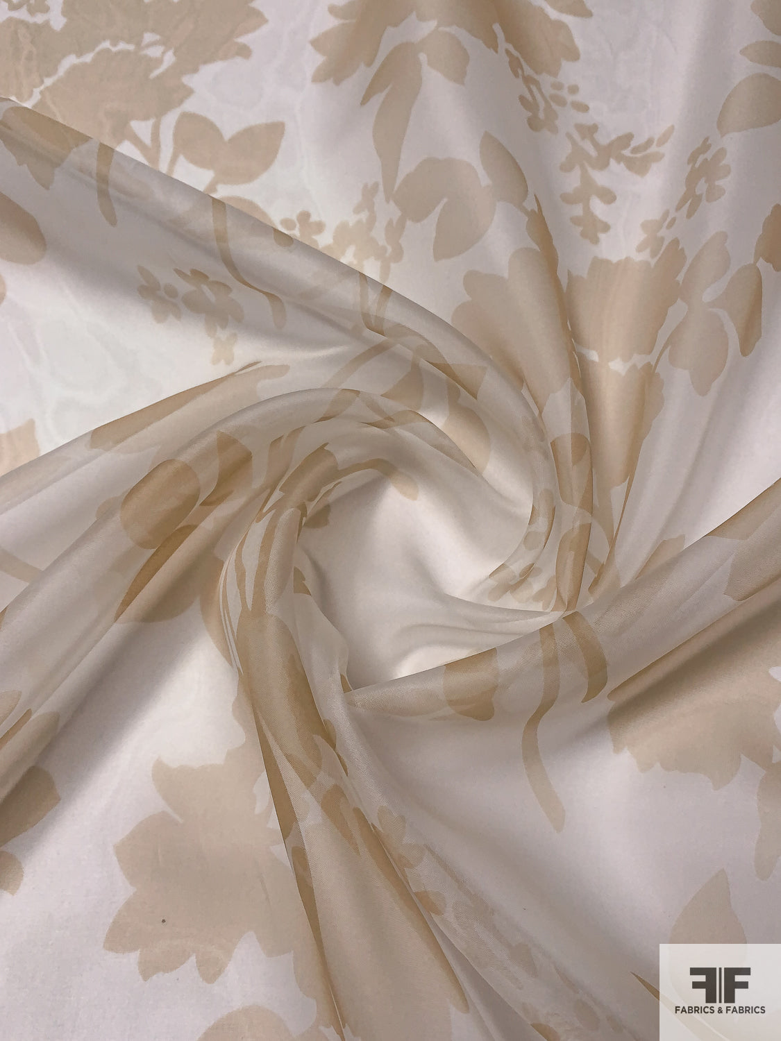 Different fabrics. Organza, chiffon, silk, jacquard are spread out on the  table. View from above. Beige silk, brown organza, golden mesh fabric for  sewing clothes. Stock Photo